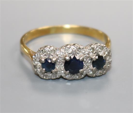 A triple cluster diamond and sapphire ring, 18ct gold shank